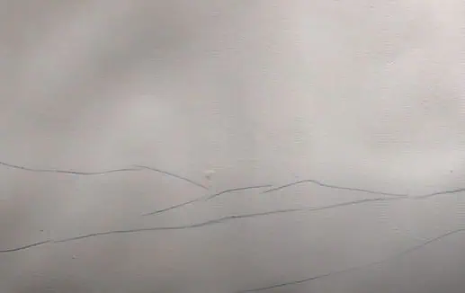 A simple pencil sketch showing the initial outline of a landscape scene step by step.